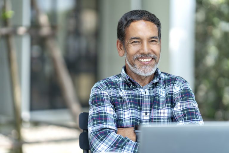 Portrait of happy mature man with white, grey stylish short bear