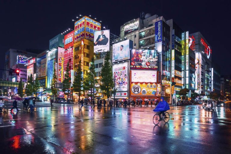 Neon lights and billboard advertisements on buildings at Akihabara at rainy night, Tokyo, Japan