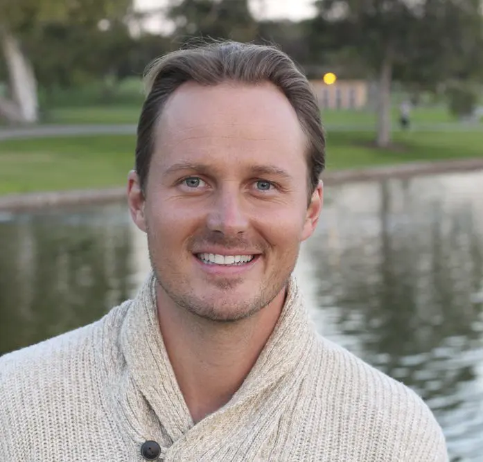 Young handsome man with lake in background