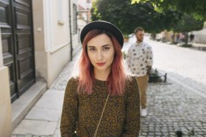 beautiful stylish girl with pink hair looking at camera, boyfrie