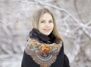 Beautiful Russian woman in a scarf in winter