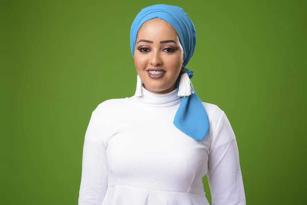 Young African Muslim woman against chroma key with green background