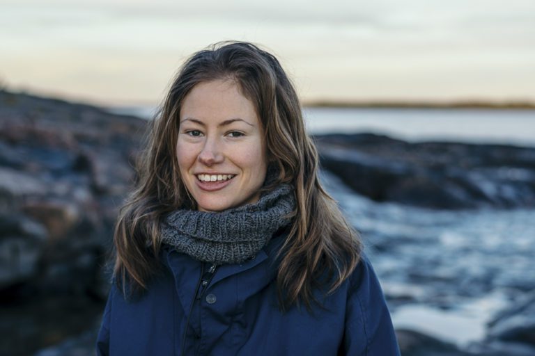 woman smiling on the beach fall weather