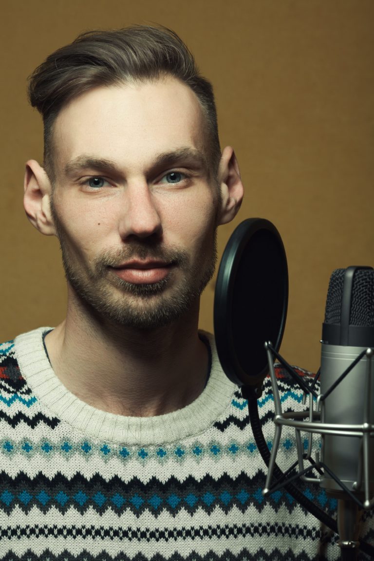 Radio dj concept. Portrait of handsome young man with blond hair