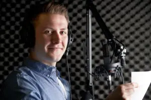 Man In Recording Studio Talking Into Microphone